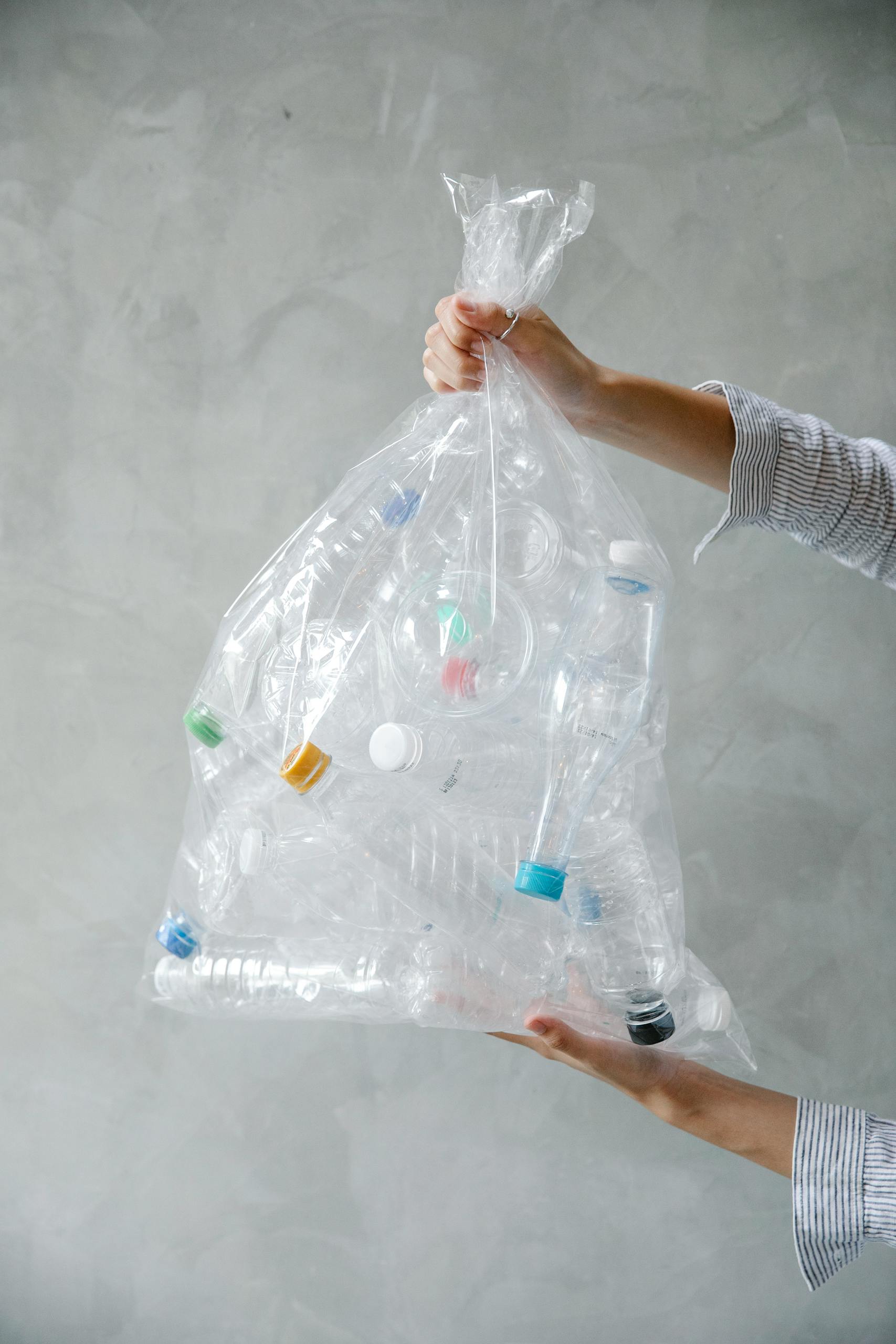 A collection of plastic bottles in a clear bag promoting recycling and environmental awareness.